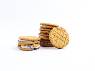 Stack of sandwich cookies with cream and blueberry filling on a white background
