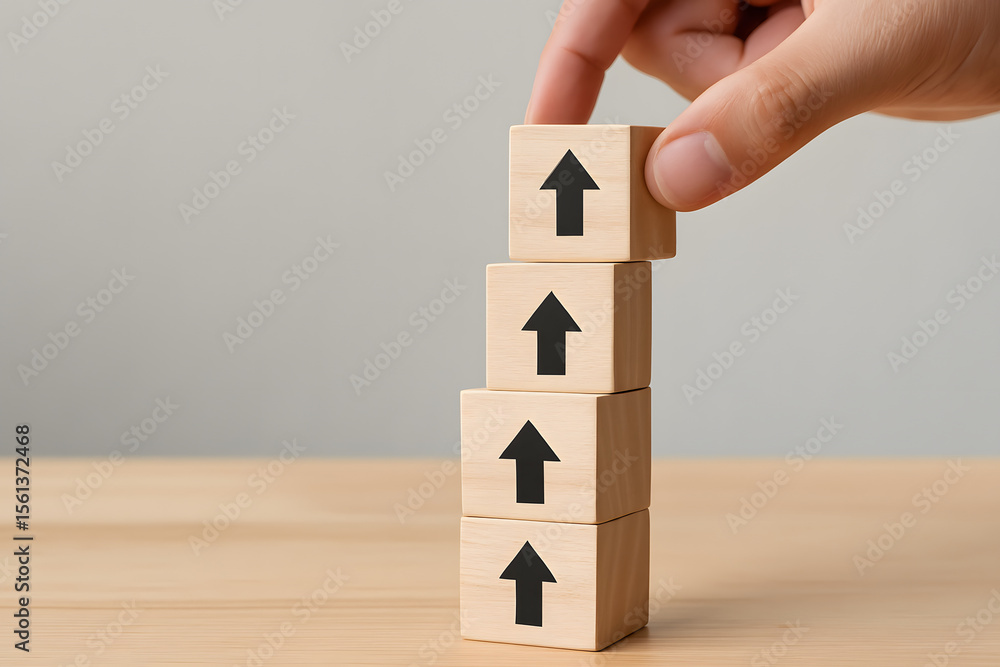 Poster growth and progress: hand placing a wooden block with an upward arrow on a growing stack of similar 