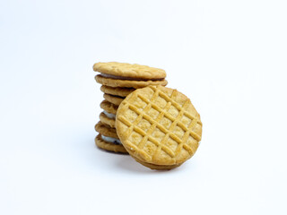 Stack of sandwich cookies with cream and blueberry filling on a white background