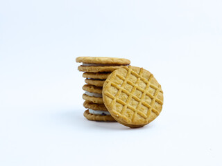 Stack of sandwich cookies with cream and blueberry filling on a white background