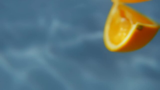 Orange slice oxidizing in time-lapse underwater