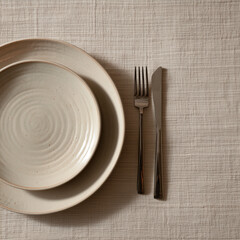 Minimalist table setting on textured beige tablecloth with ceramic plate and cutlery.