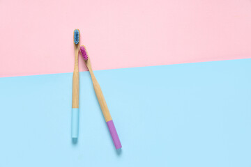 Male and female toothbrushes on color background