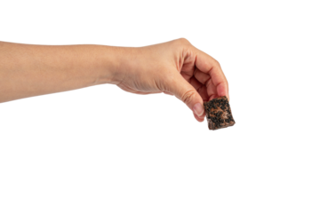 Nougat is a chocolate snack in hand on a transparent background.