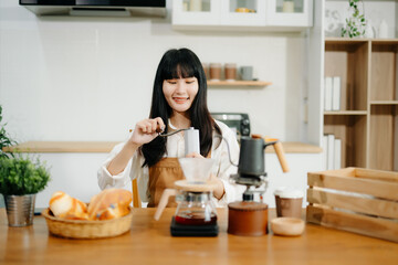 Young female entrepreneur hanging a welcome sign in front of a coffee shop. Beautiful waitress