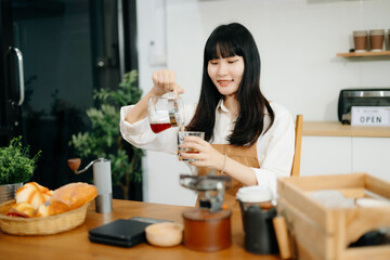 Asian barista brewing fresh espresso. Enjoy a cozy, trendy cafe experience with high quality beans in home or cafe