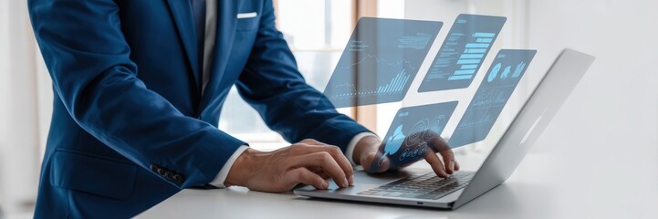 Businessperson working on a laptop with holographic data overlays.