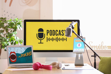 Podcaster's workplace with gadgets and microphone in studio