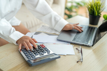 Human use calculator and calculate bills and paying bill, credit card, tax and vat, payment, concept of money management and business report with financial documents, financial accounting concept