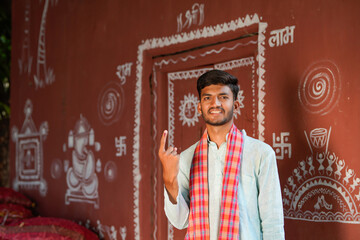 Young Indian farmer showing finger after voting