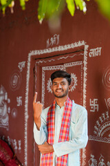 Young Indian farmer showing finger after voting
