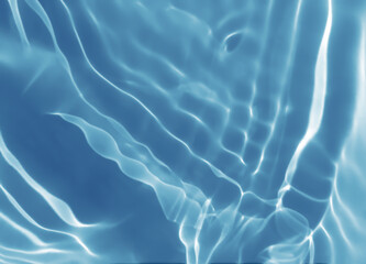 Abstract blurred shades of blue water background. Light and shadow ripples or splashes surface of water texture. Water waves with shining and reflection pattern photography for​ design artwork.
