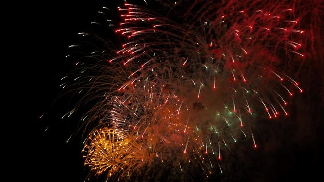Colorful fireworks exploding in the night sky during a celebration