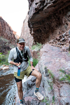 White male in his early 50s runs the Grand Canyon.