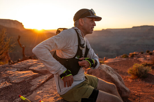 White male in his early 50s runs the Grand Canyon.
