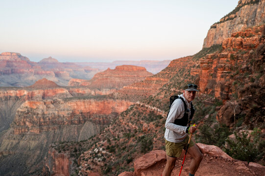 White male in his early 50s runs the Grand Canyon.