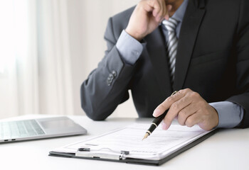 Businessman executive reviewing new job applicant documents, reading resume and interviewing,...