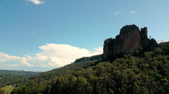 Mountain peak stands in front of storm clouds brewing in the background.