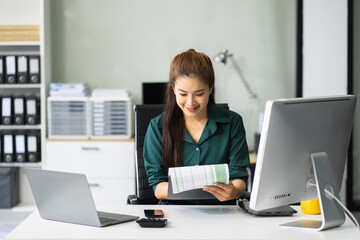 Businesswoman analyzing financial graphs, calculating company expenses, and planning investments,...