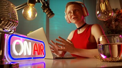 Young Woman Broadcasting a Podcast in a Modern Studio Setting