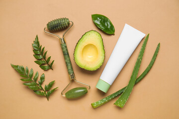 Composition with natural cosmetic product, ingredients and facial massage tool on color background