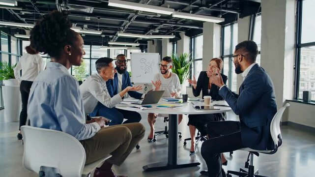 Large team brainstorm in modern open office with rolling chairs, team ideas circle, team harmony boosts output. Concept collaborative workflow.
