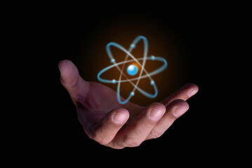 Businessman hand holding creative atom. Nuclear fusion concept, endless energy, future...