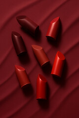 Explore vibrant lipsticks on a rich background, showcasing their artistry in beauty and fashion