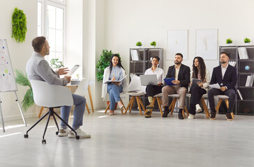 Meeting room gathering, leader man presenting lecture talking with diverse hr group of people...