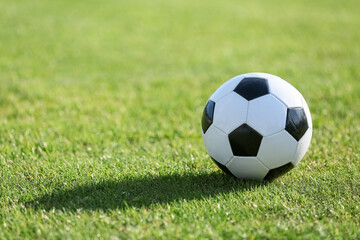 Soccer ball on green grass, closeup