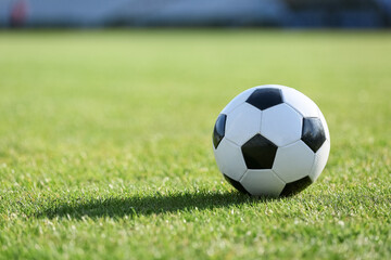 Soccer ball on green grass, closeup