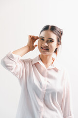 Asian woman rejoicing, looking happy, champion, fist pump gesture, standing over white background....