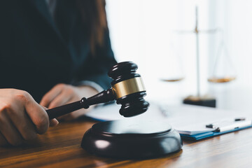 Justice and lawfirm concept. Female lawyer in office with brass scale. Woman hand gavel to bang. Law and justice trial session. Business lawyer notary stamping agreement, company secretary, validity.