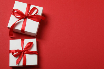 Top view of gift box trinket, fir branch, on red background, space for text