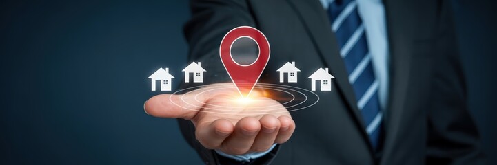 A hand displays a location marker and multiple house icons, suggesting real estate services.