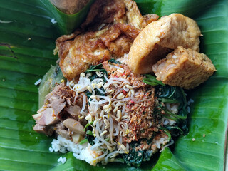 Nasi pecel or sego pecel is a typical Javanese Indonesian rice dish served with pecel sauce, which...