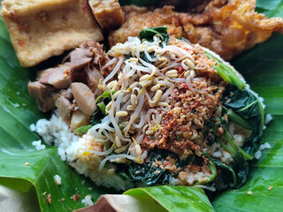 Nasi pecel or sego pecel is a typical Javanese Indonesian rice dish served with pecel sauce, which...