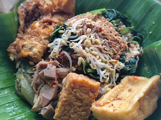 Nasi pecel or sego pecel is a typical Javanese Indonesian rice dish served with pecel sauce, which...