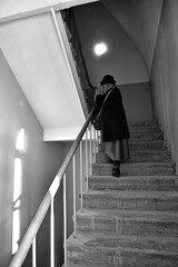 Woman is climbing up the stairs.