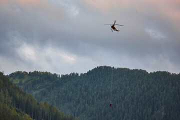 Helicopter rescue training simulation in a mountain range wood. Accident