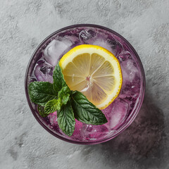 Top-down view of purple-hued iced drink with lemon slice and mint leaves,