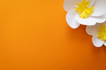 summer paper flowers on bright orange background with copy space. kids art craft diy gift