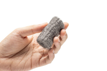 Hand holding steel wool, also known as iron wool or wire sponge. commonly used as an abrasive for...