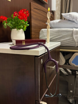 Hospice Bedside Scene with Bible, Candle, and Stethoscope, Palliative Care and End of Life Spiritual Support Concept in Hospital Setting, Faith, Compassion, and Dignity in Healthcare Concept