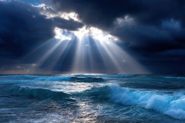 Dramatic sunlight breaks through clouds over turbulent ocean waves at sunset