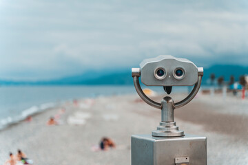 Seaside Binocular Viewer with Blurred Beach Background