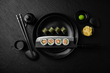 Maki. Sushi composition on black background. The Art of Japanese Cuisine. Food photography for menu and sushi bar decoration
