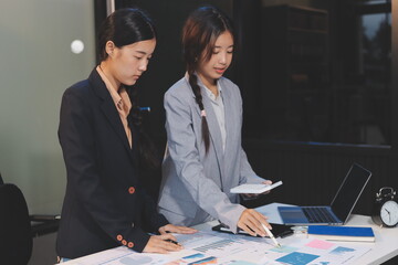  teamwork of tired young business with documents tax laptop computer in office. Sad, unhappy,...