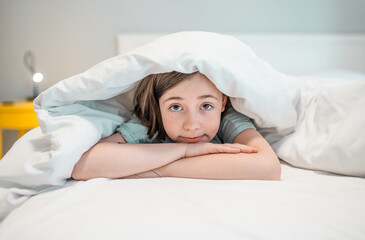 Child in a bedroom before going to sleep.
