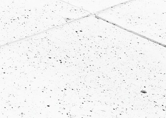 Close-up of textured white surface with scattered black dots